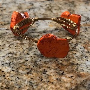 Gold wire bangle bracelet with orange stone